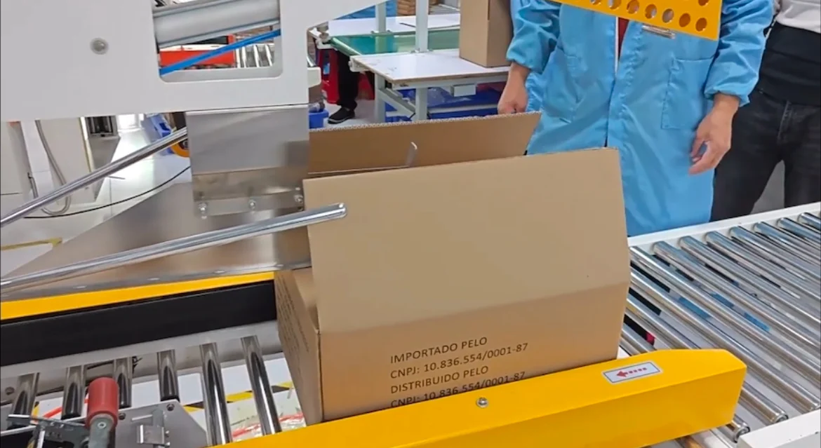 Cartons passing through the box sealing equipment