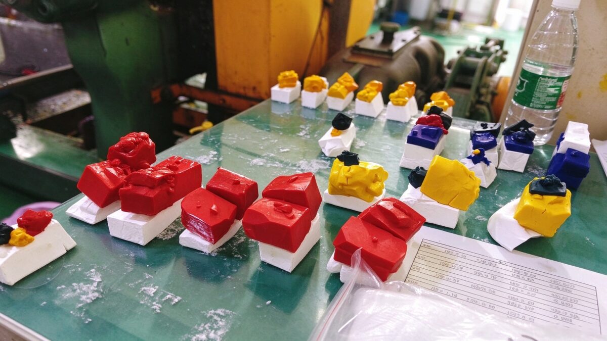 Factory workbench with multi-color silicone test samples for pre-production batch consistency check
