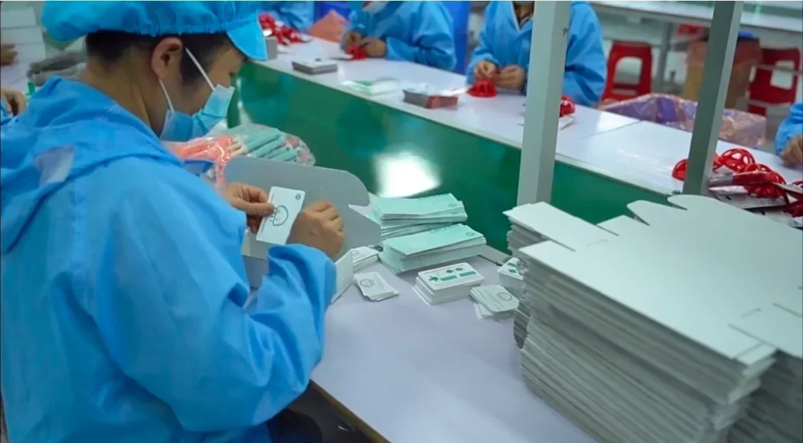Workers preparing silicone product packaging