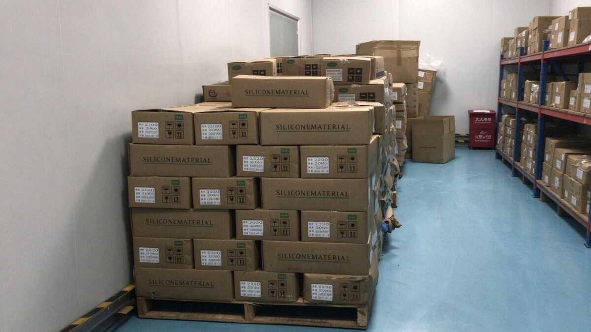 Silicone raw material boxes in warehouse, checking stock to avoid OEM production delays