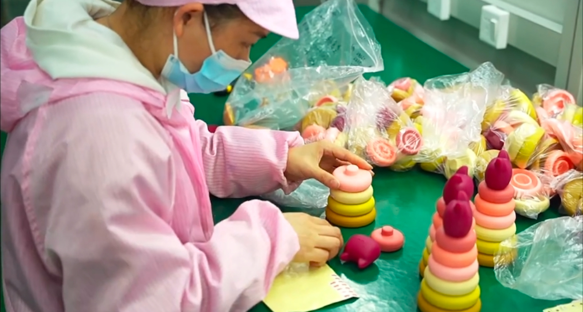 Worker checking silicone toy components